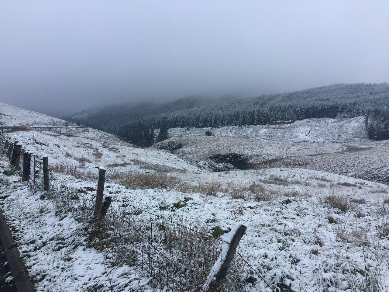 Light snow covering over a cloudy mountain landscape