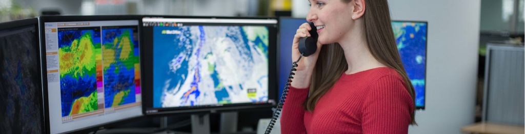 A meteorologist from the Met Office providing a specialist forecast for a customer on the phone.