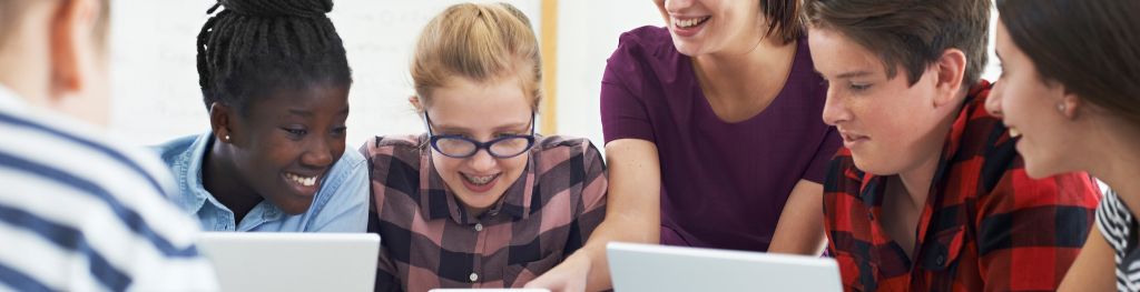 Group of students around a laptop