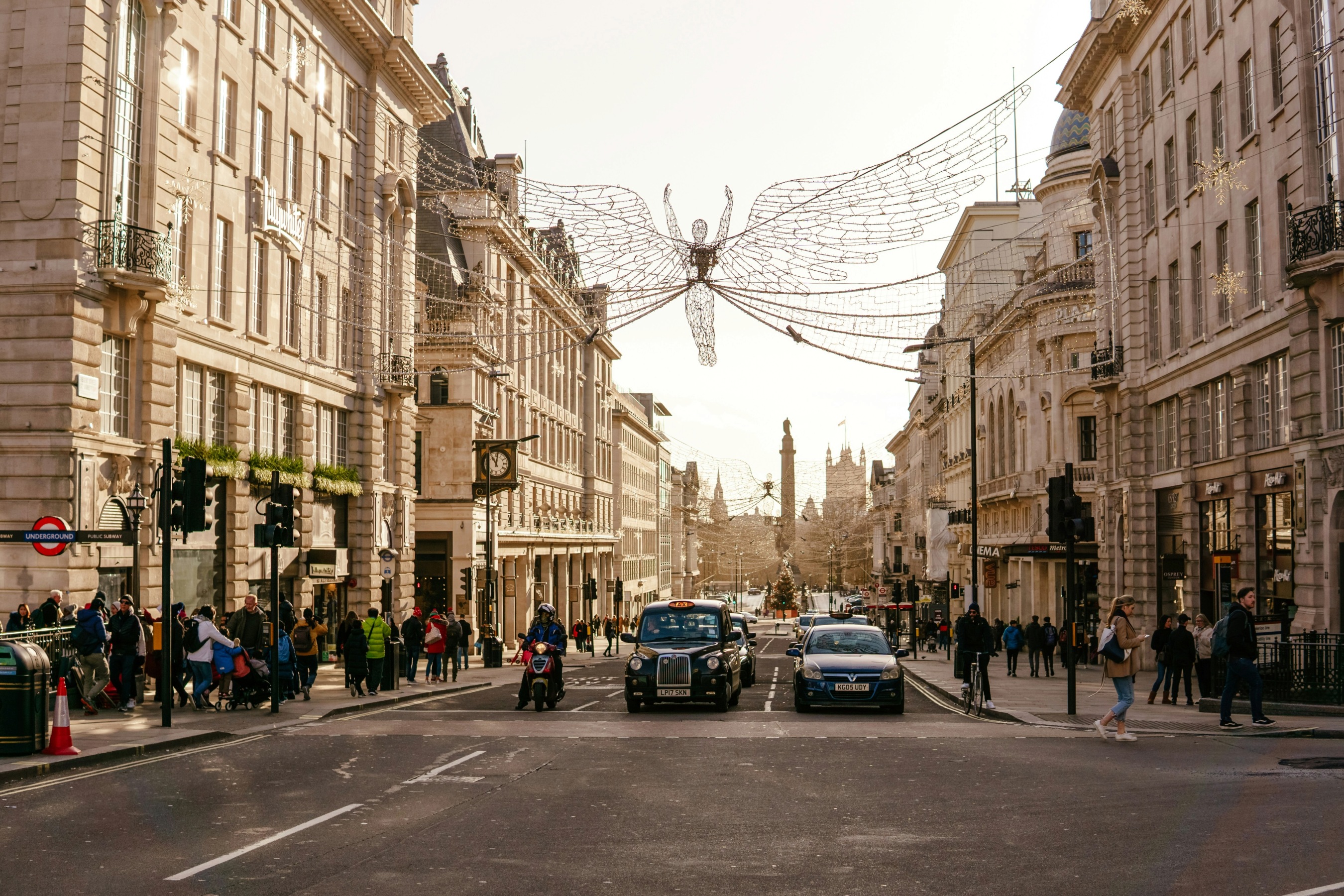 A busy street with cars and people