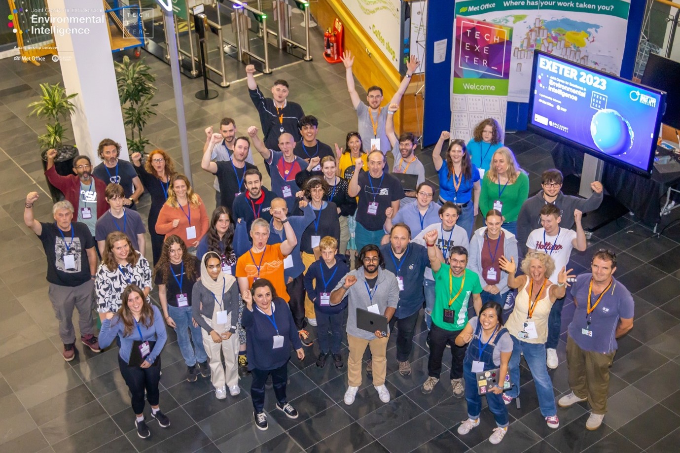 Participents of the last NASA Space Apps Challenge waving to the camera from Met Office HQ.